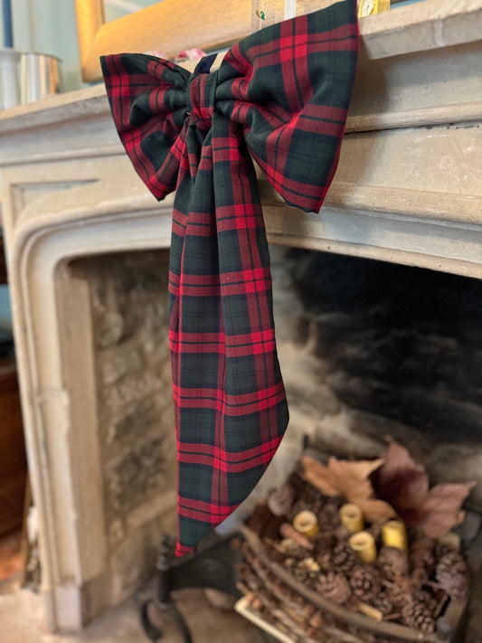 Christmas tartan bow on a fireplace